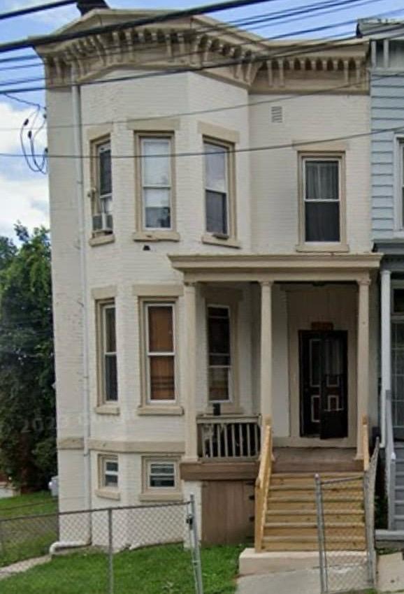 Italianate house featuring a porch