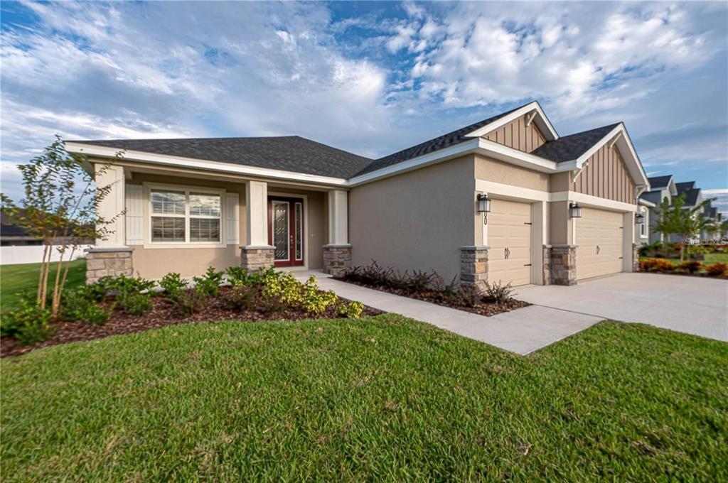 a front view of house with yard and green space