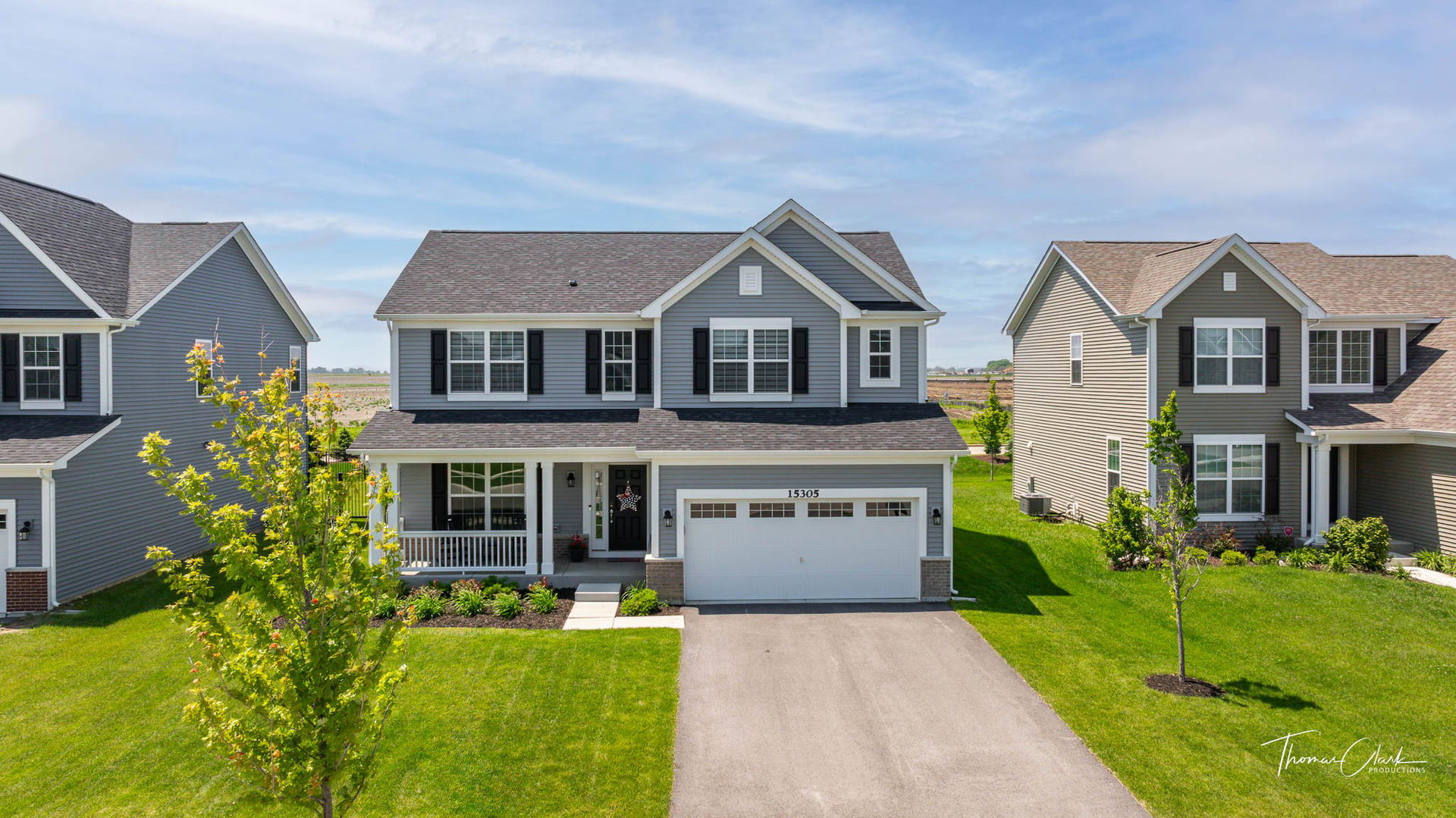 a front view of house with yard and green space