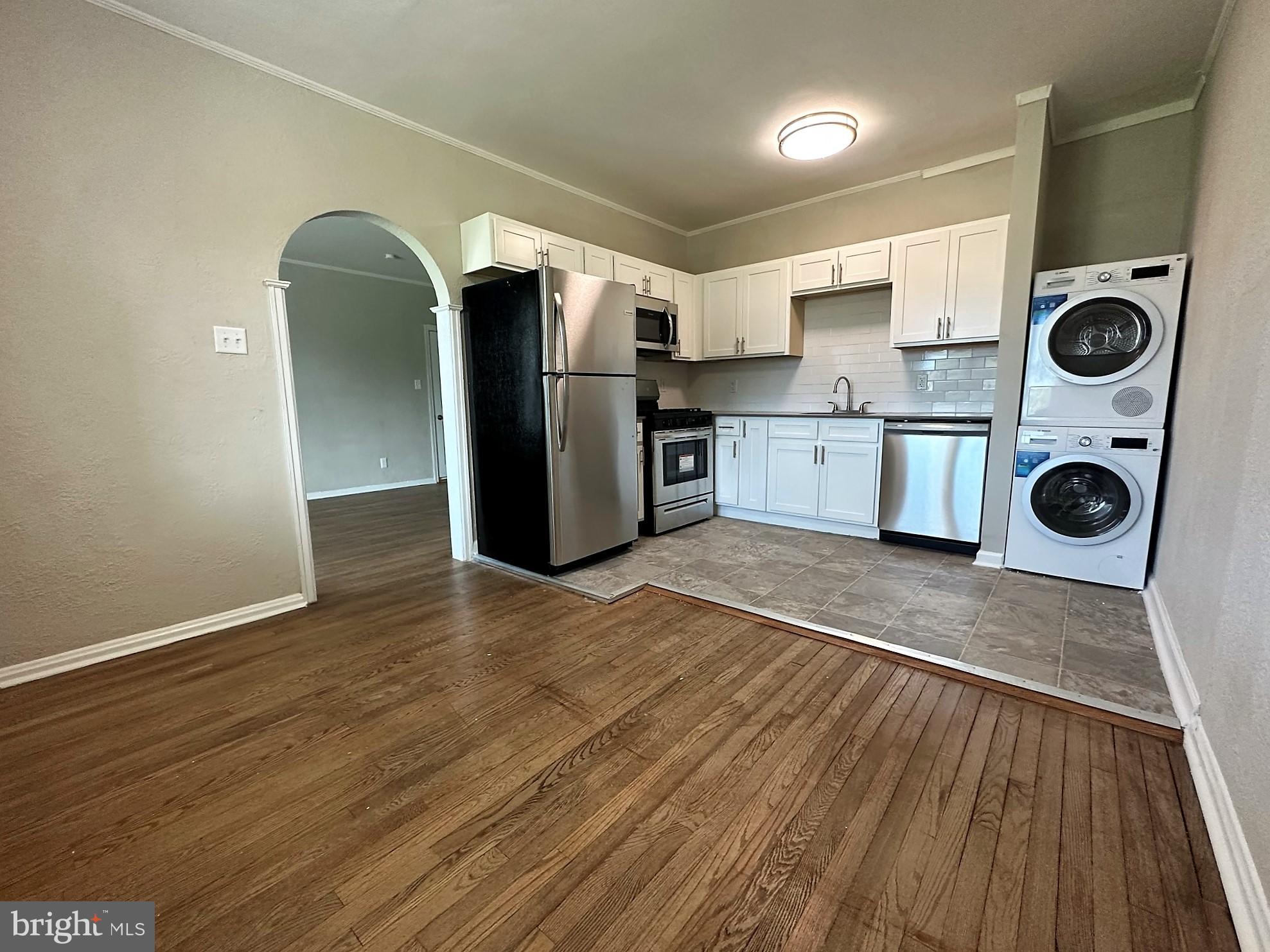 a kitchen with stainless steel appliances granite countertop a refrigerator and a stove