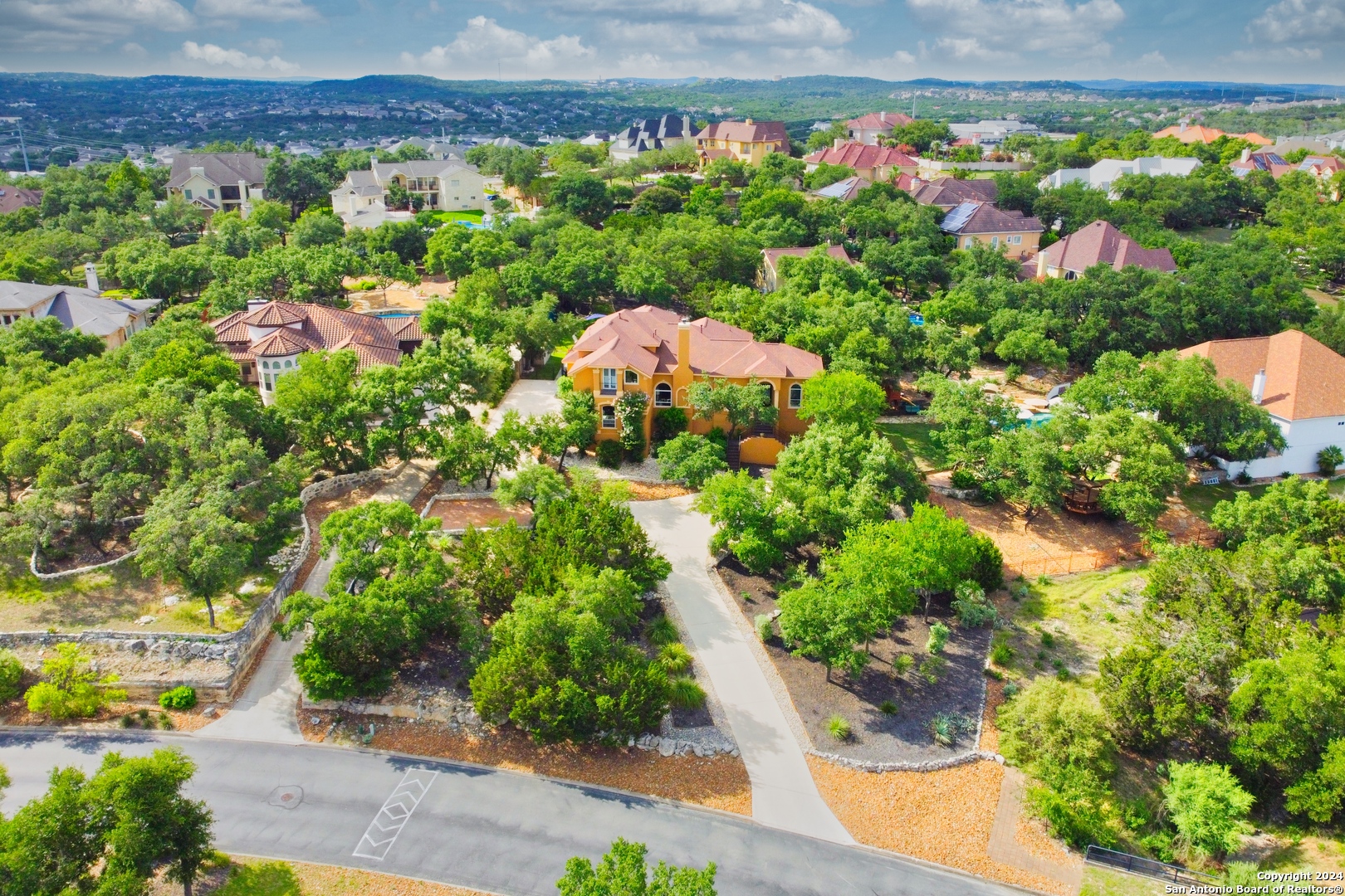 an aerial view of a house with a yard and garden