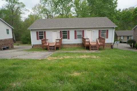 a view of a house with a backyard and sitting area