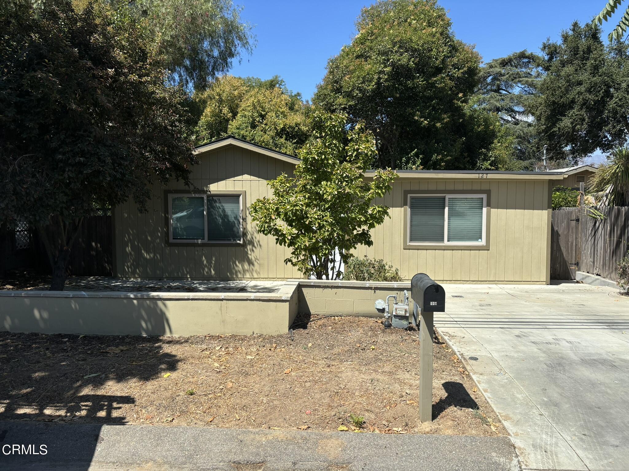 a backyard of a house with yard and outdoor seating