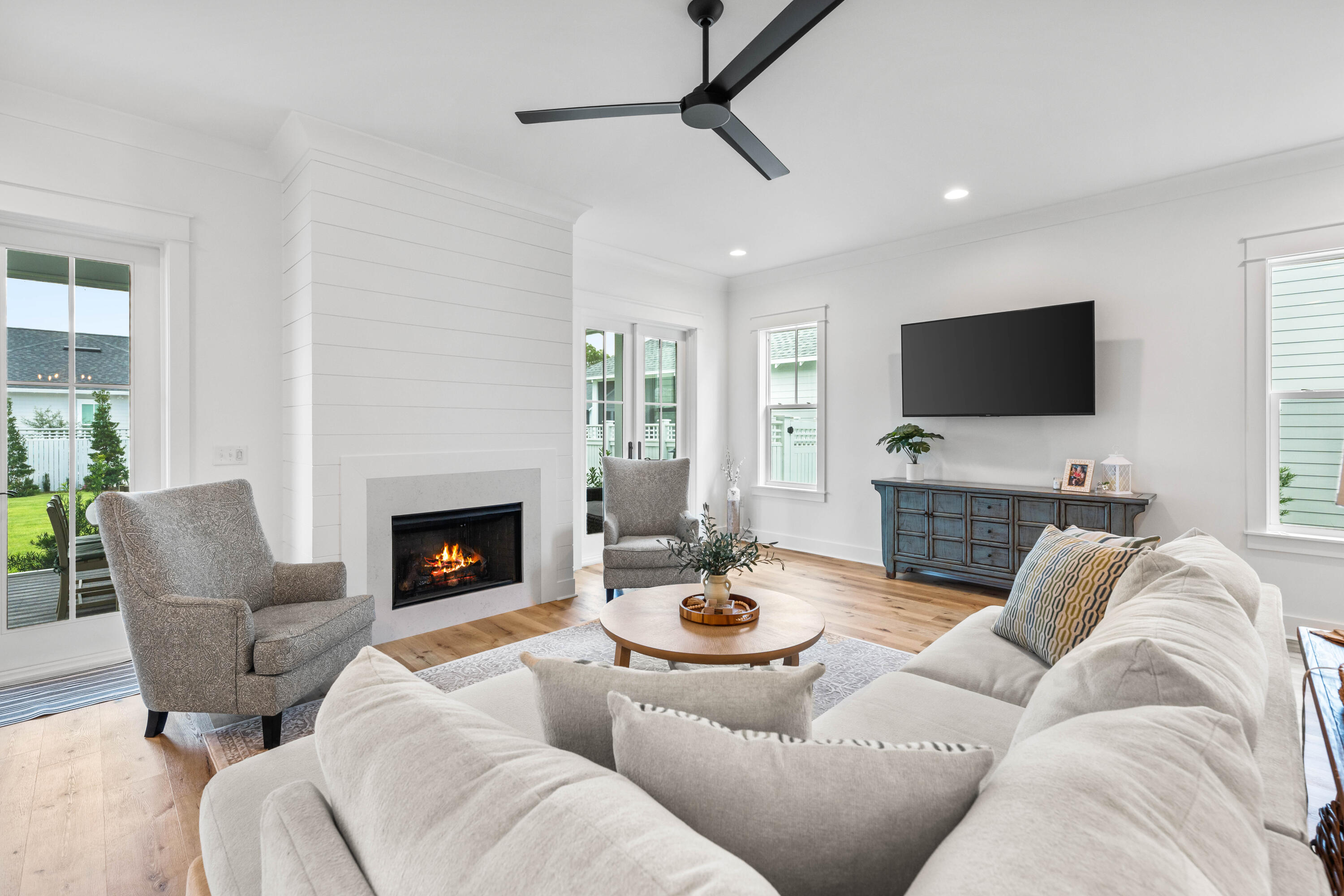 a living room with furniture a fireplace and a flat screen tv