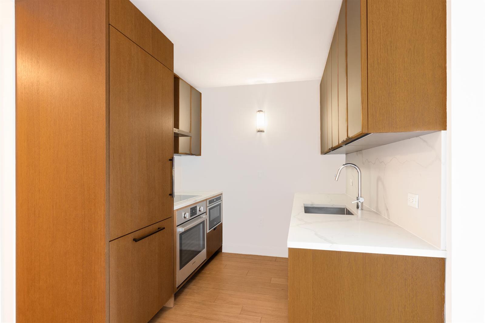 a kitchen with stainless steel appliances a refrigerator and a sink