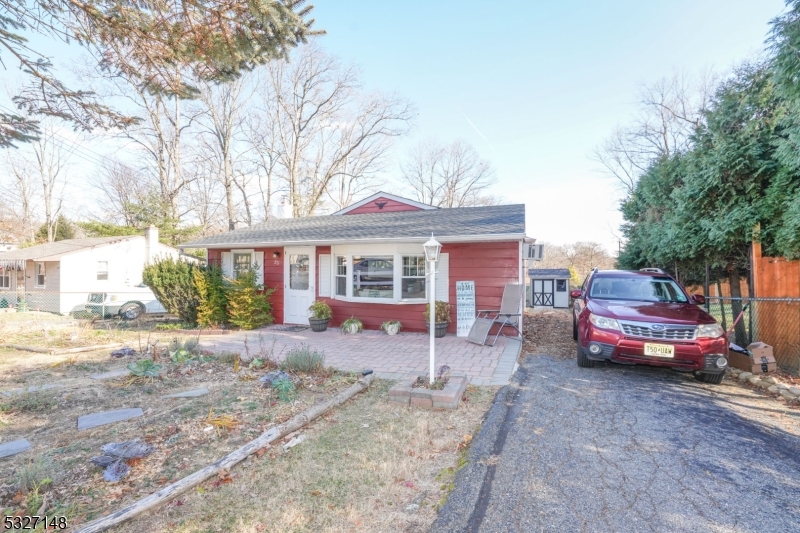 a front view of a house with a yard and seating space