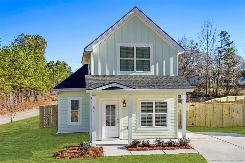 a front view of a house with a garden