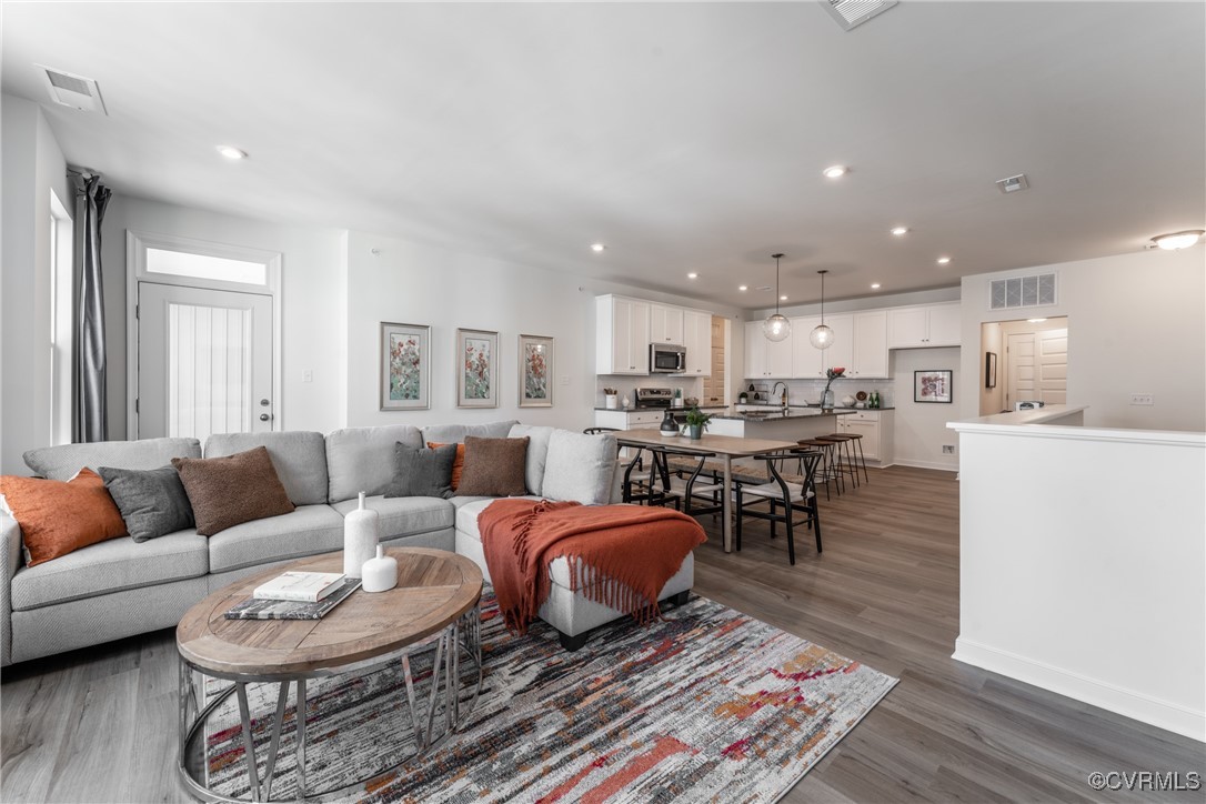 a living room with furniture and kitchen view