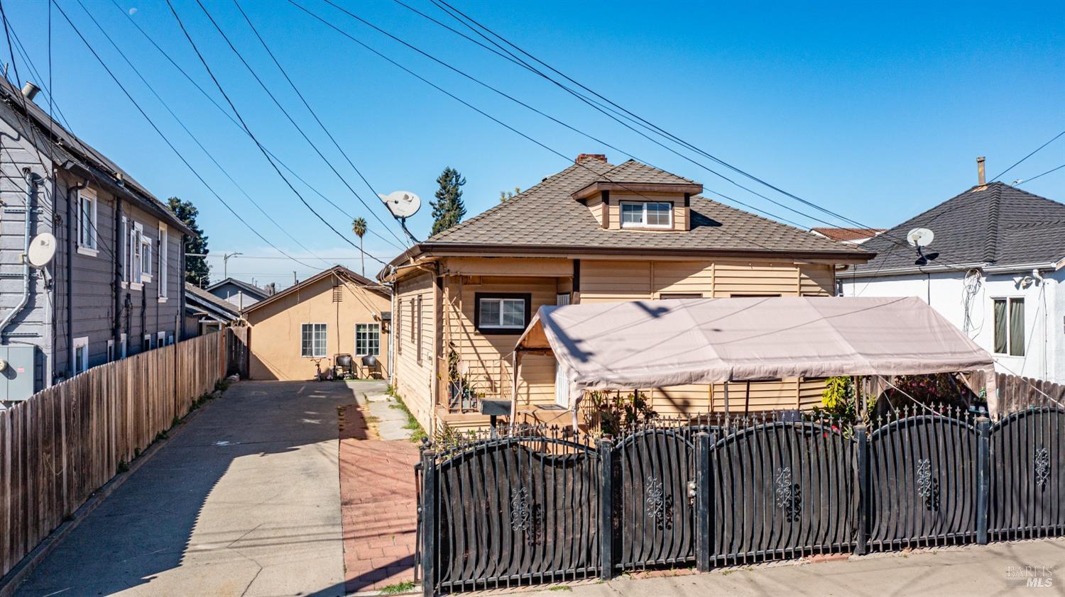 a view of a house with wooden fence