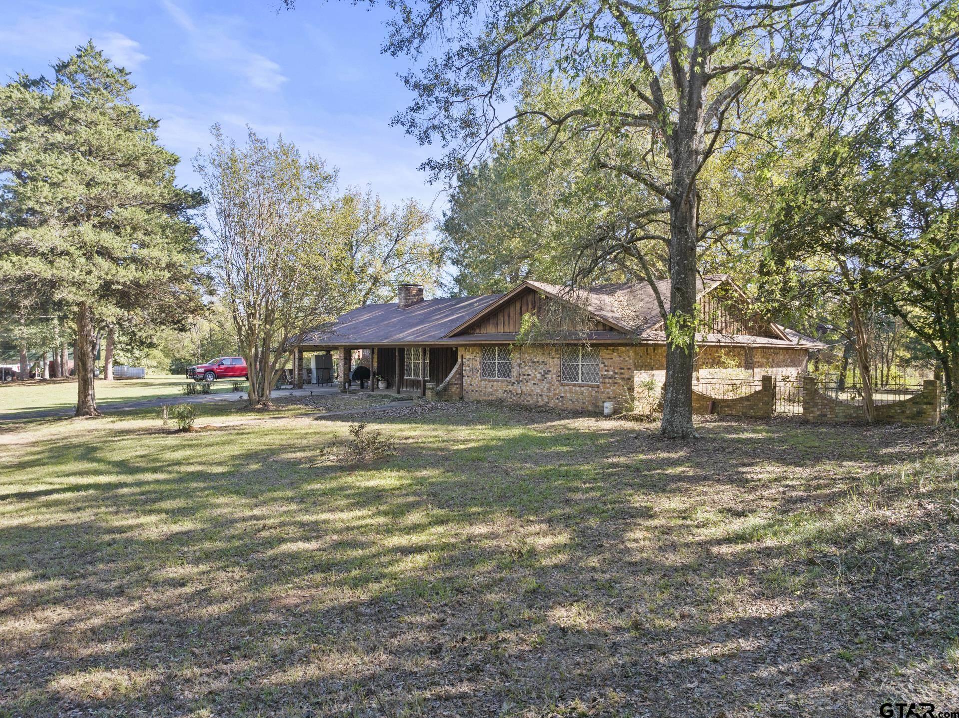 a front view of a house with a big yard