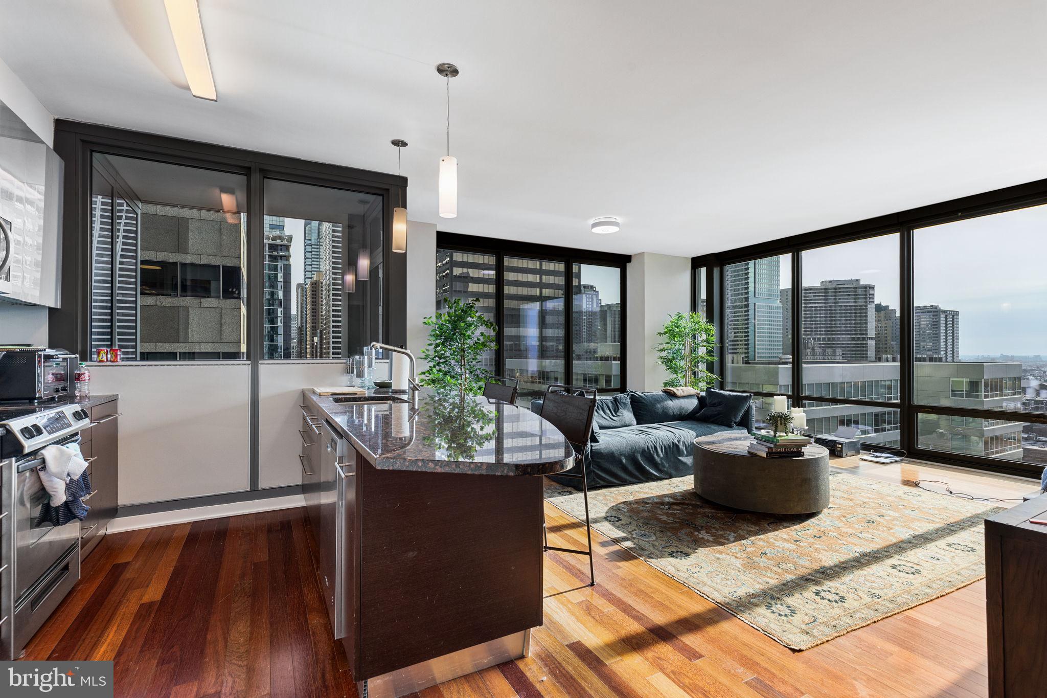 a living room with furniture and large windows