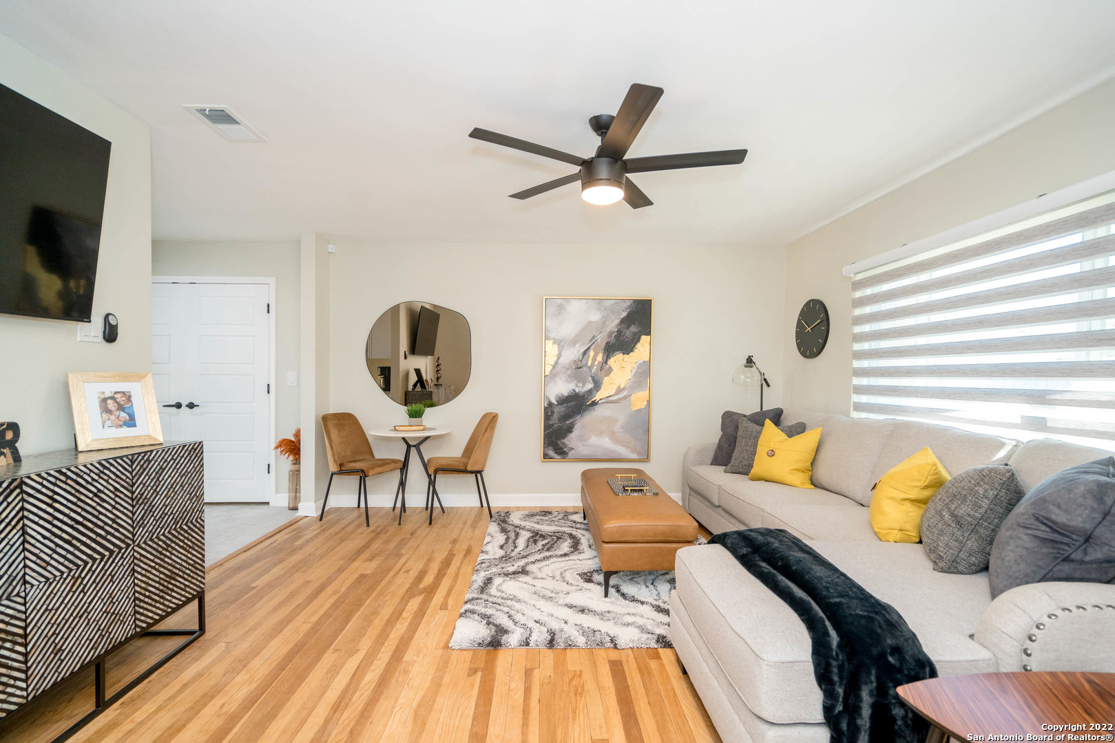 a living room with furniture and a flat screen tv