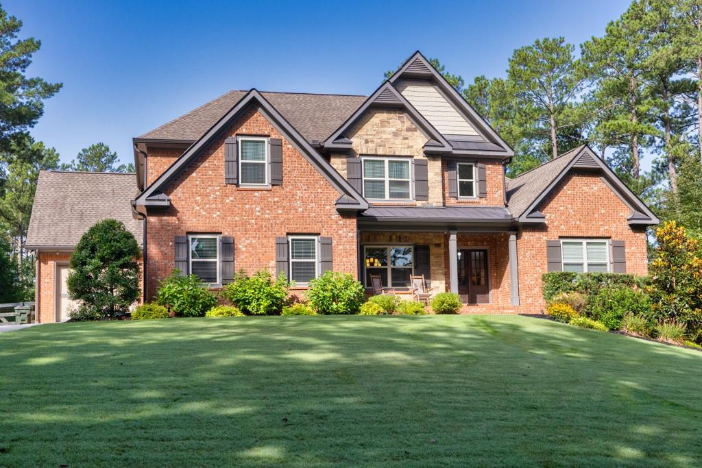 a front view of a house with a yard and trees