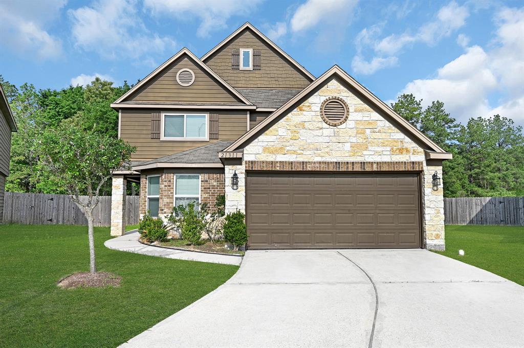 a front view of a house with a yard and garage