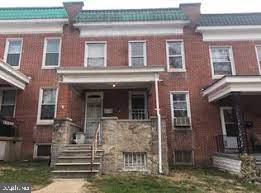 front view of a brick house with a small yard