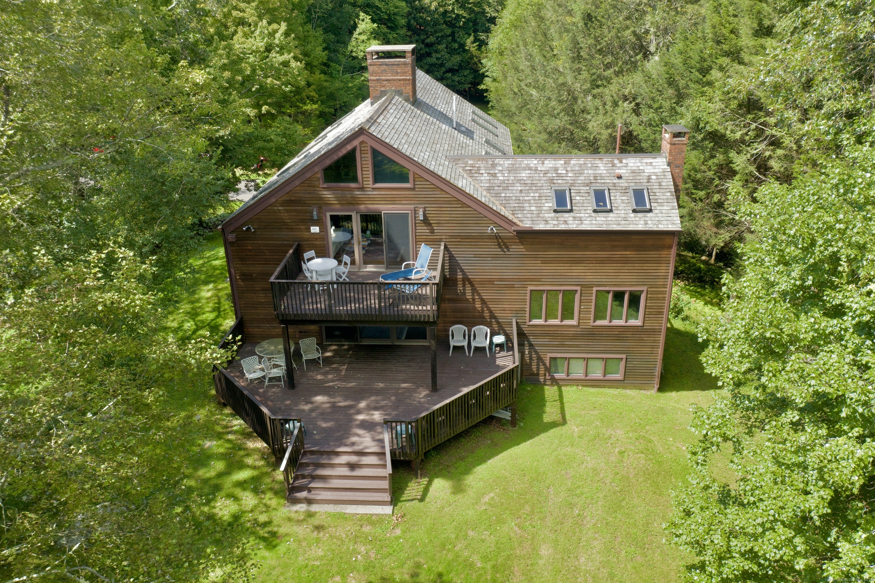 a aerial view of a house with swimming pool next to a yard