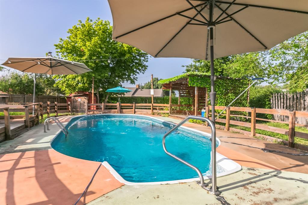 a view of a swimming pool with a patio