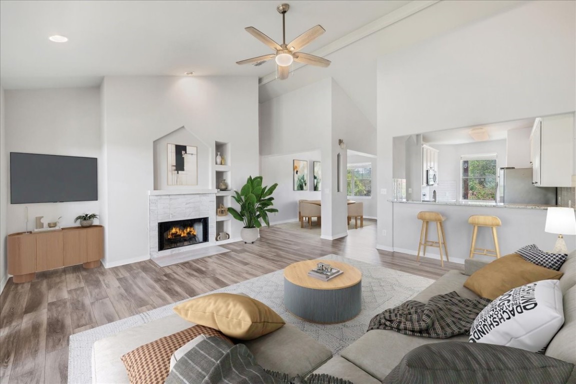 a living room with furniture a fireplace and a flat screen tv