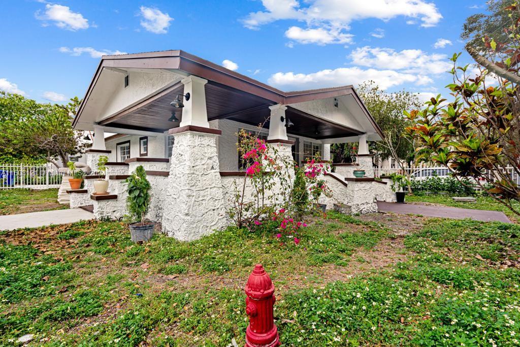 a view of a house with a yard and garden