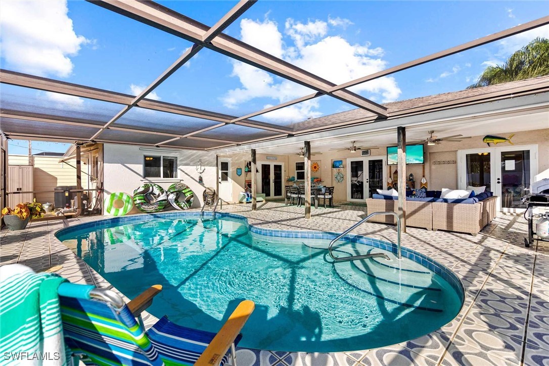 a view of a swimming pool with outdoor seating