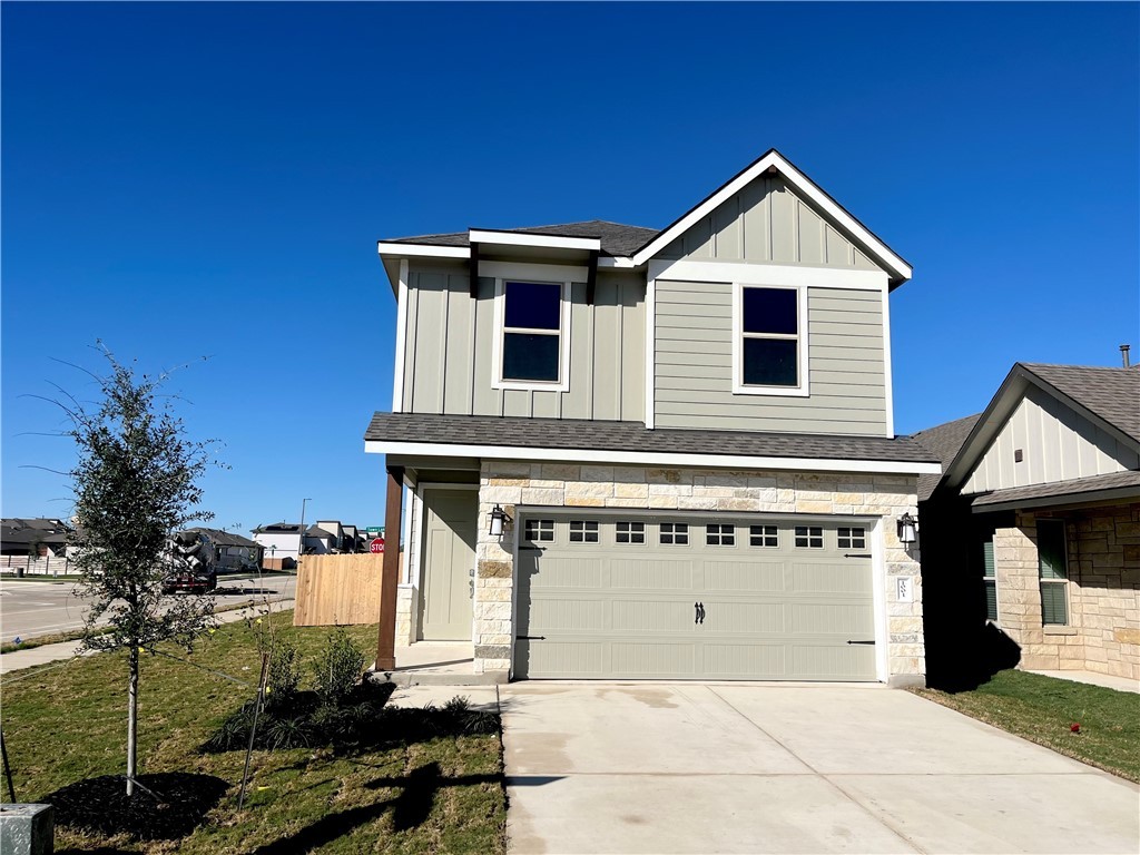 View of front of house with a garage and a front l