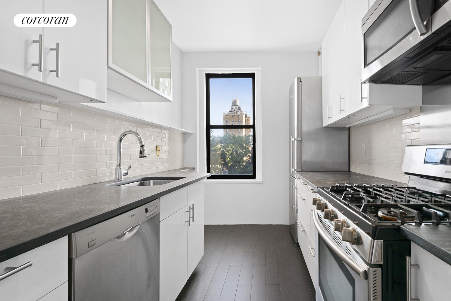 a kitchen with granite countertop a sink stove and cabinets