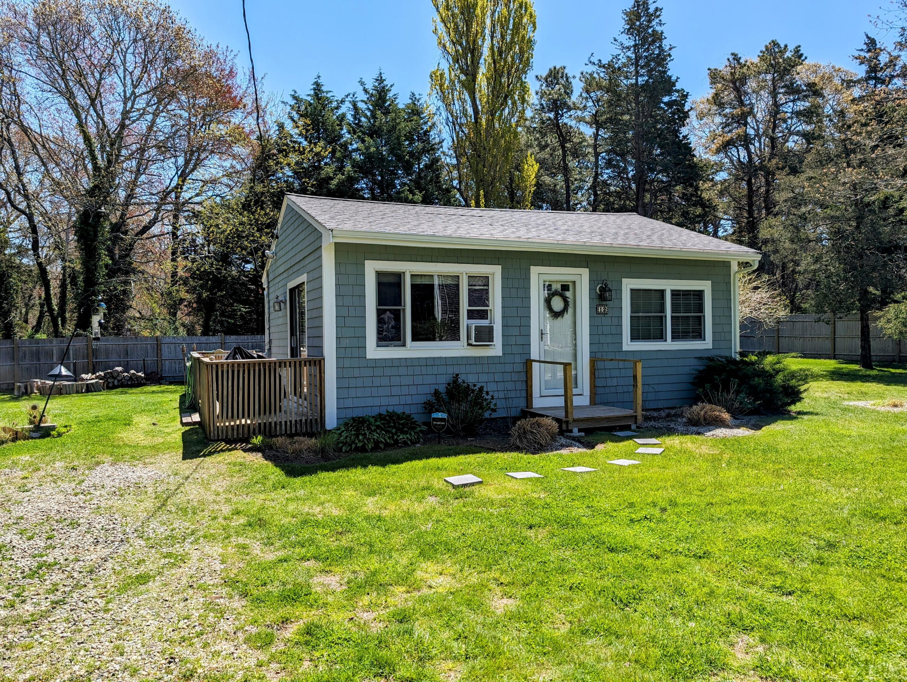 a view of a house with a yard and trees