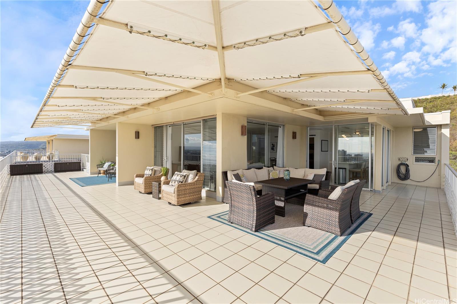 a view of a patio with dining table and chairs