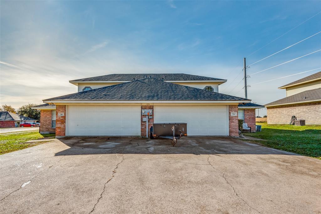 a view of a house with a yard and a garage