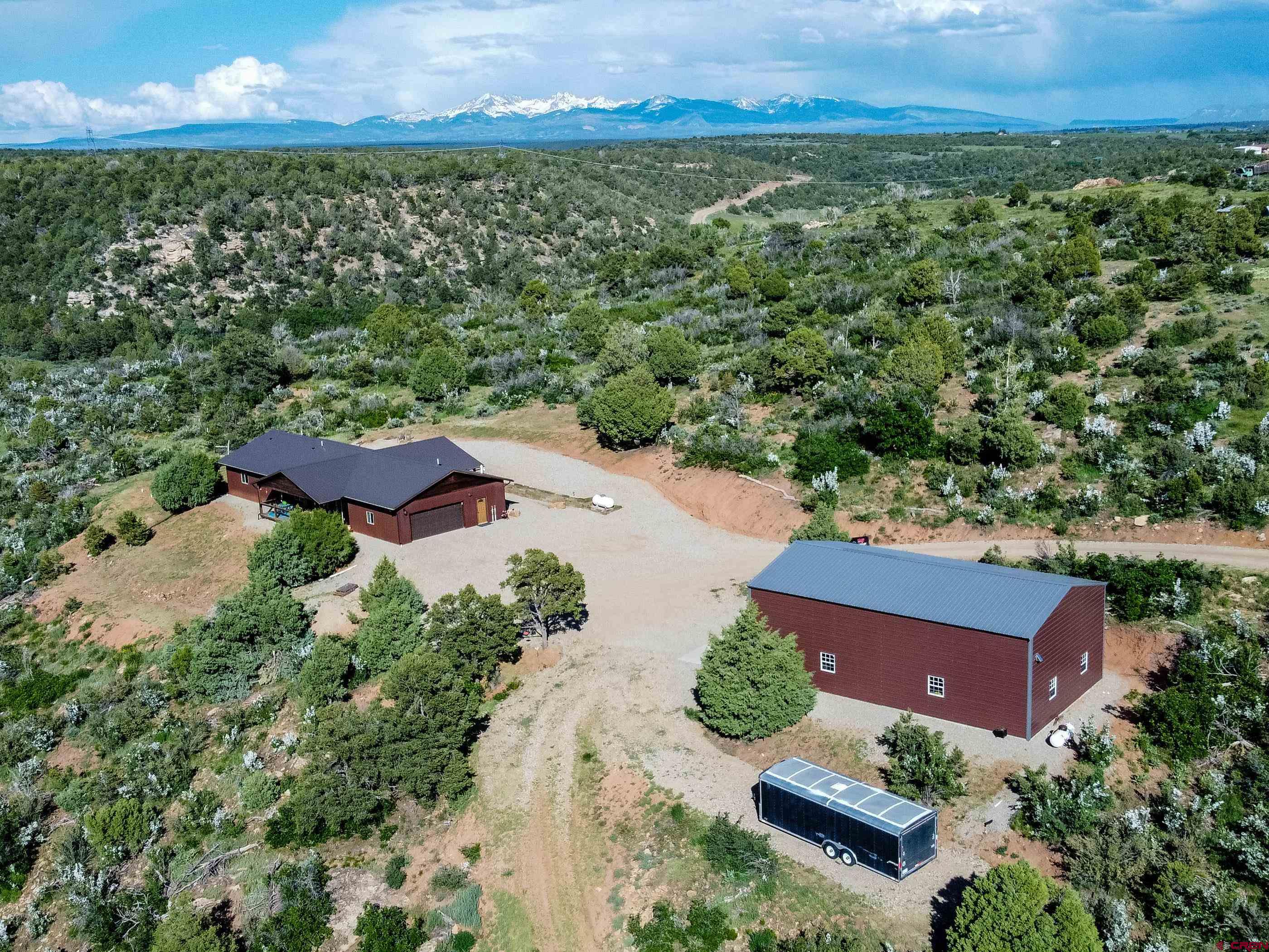 an aerial view of a house with a yard