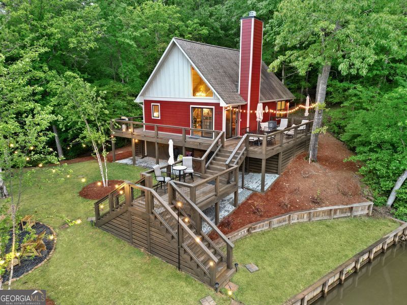 a view of a house with backyard water fountain and sitting area