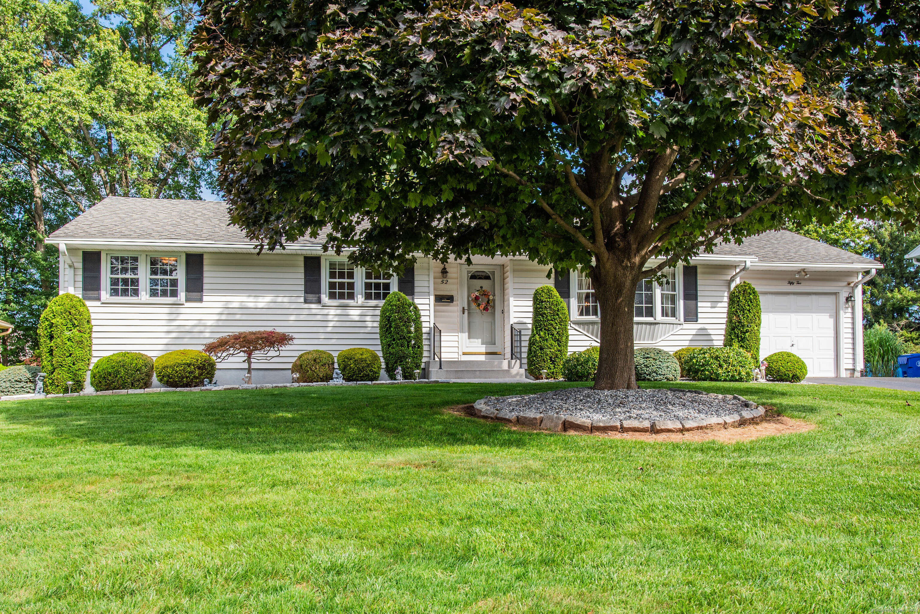 a front view of a house with a garden