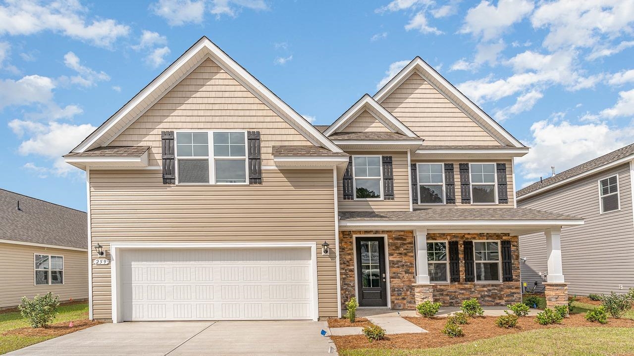 Craftsman-style home featuring a garage and a porc