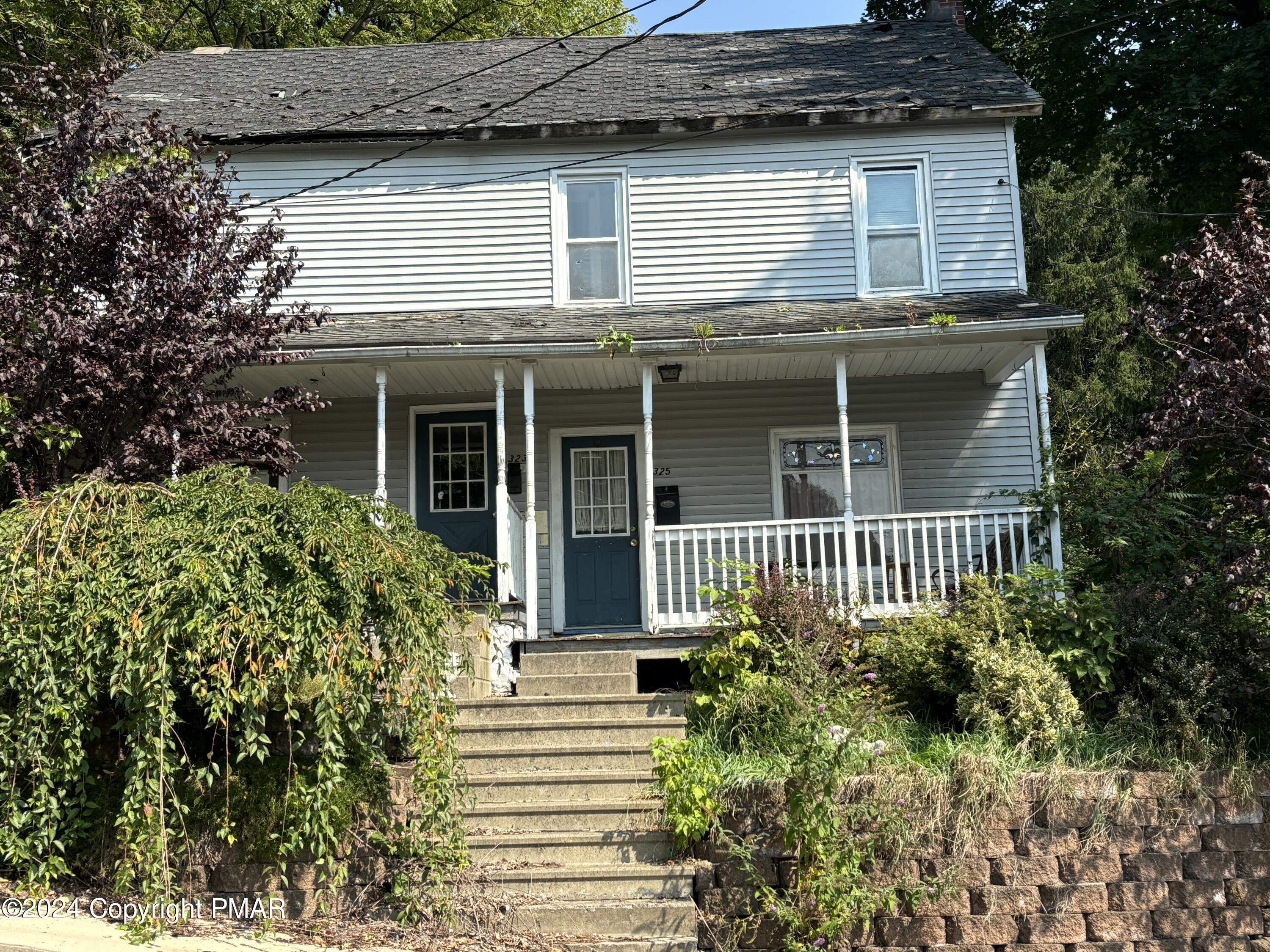 a view of a house with plants and more windows