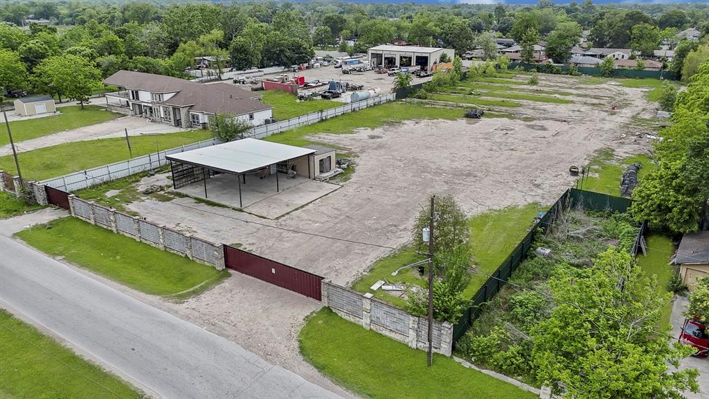 an aerial view of a house with a yard and lake