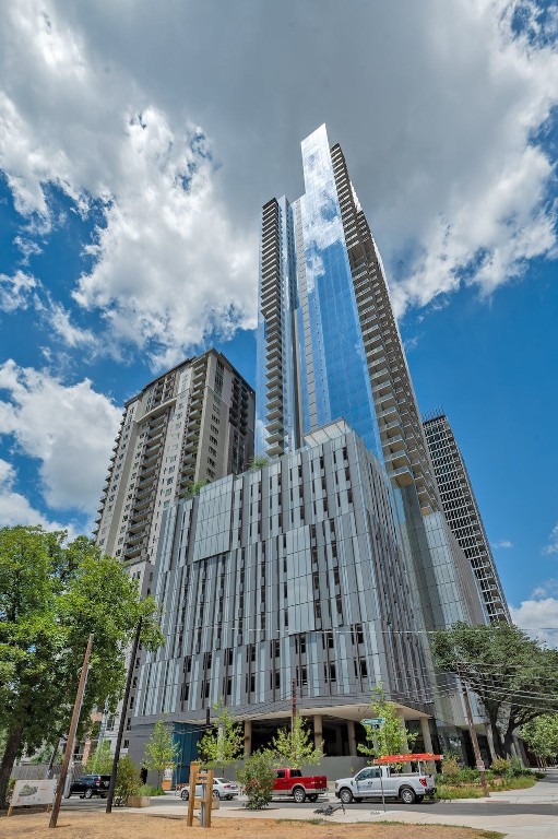 a view of a tall building next to a road