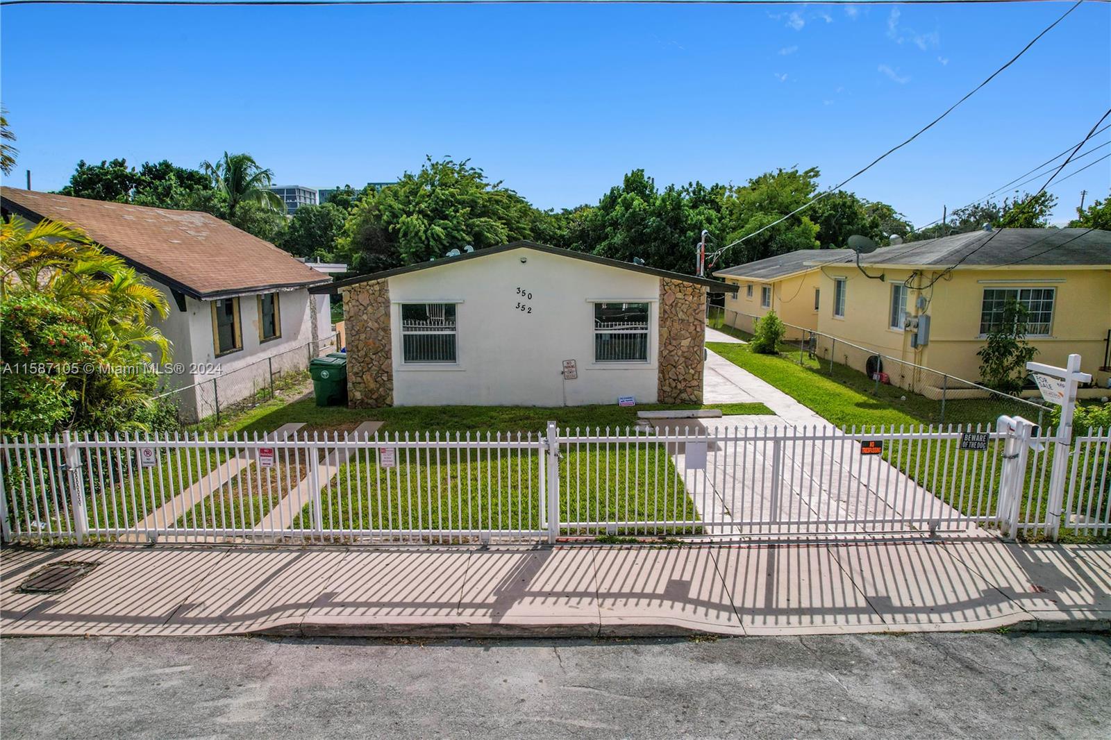 a view of a house with a wooden fence