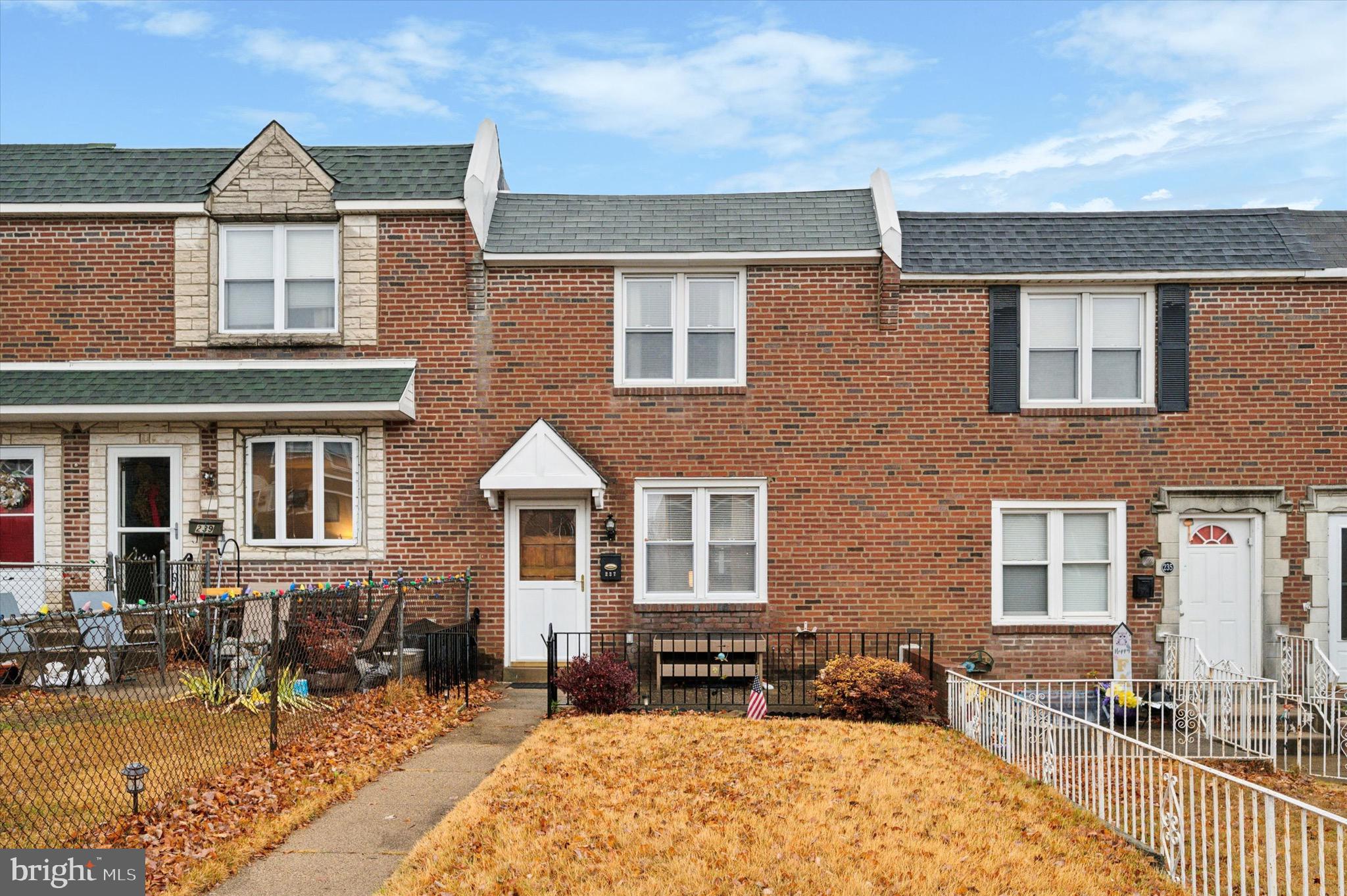 a front view of a house with outdoor seating