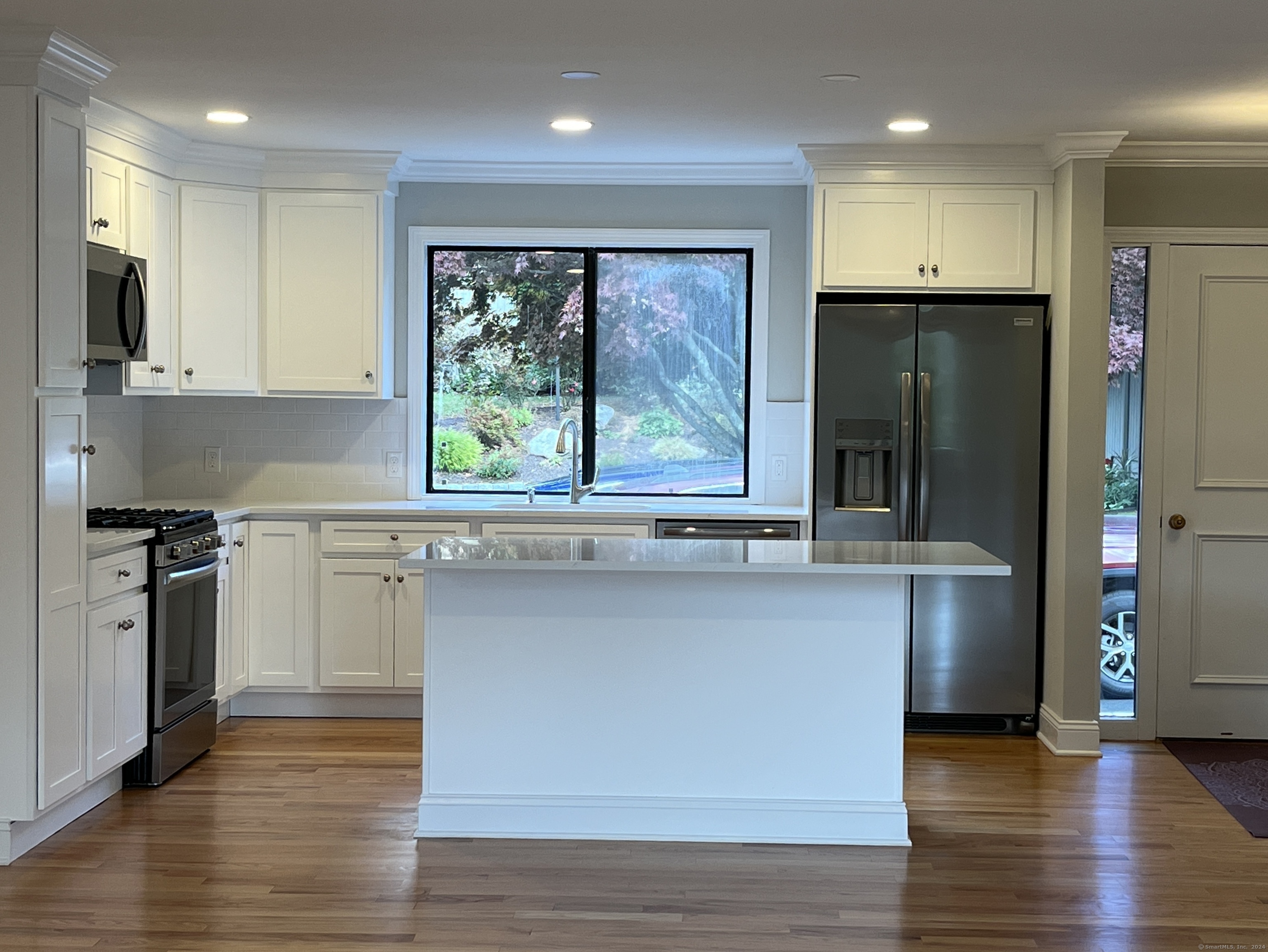 a kitchen with stainless steel appliances a refrigerator sink and cabinets