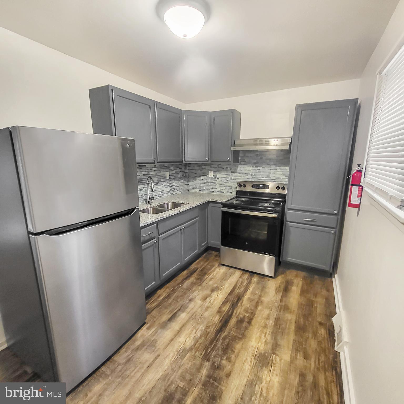 a kitchen with a refrigerator sink and stove