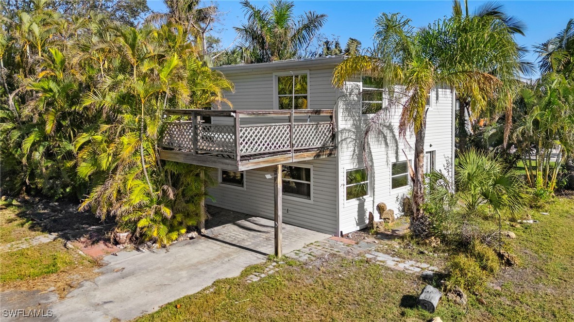 a view of a house with a tree next to a yard