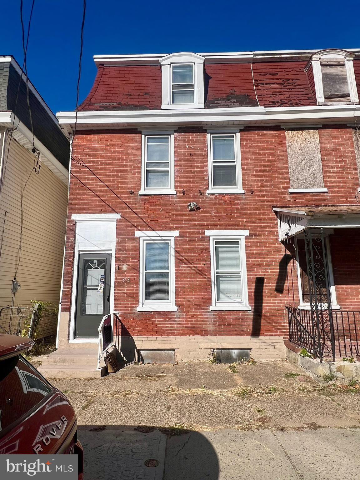 a view of a brick house with many windows