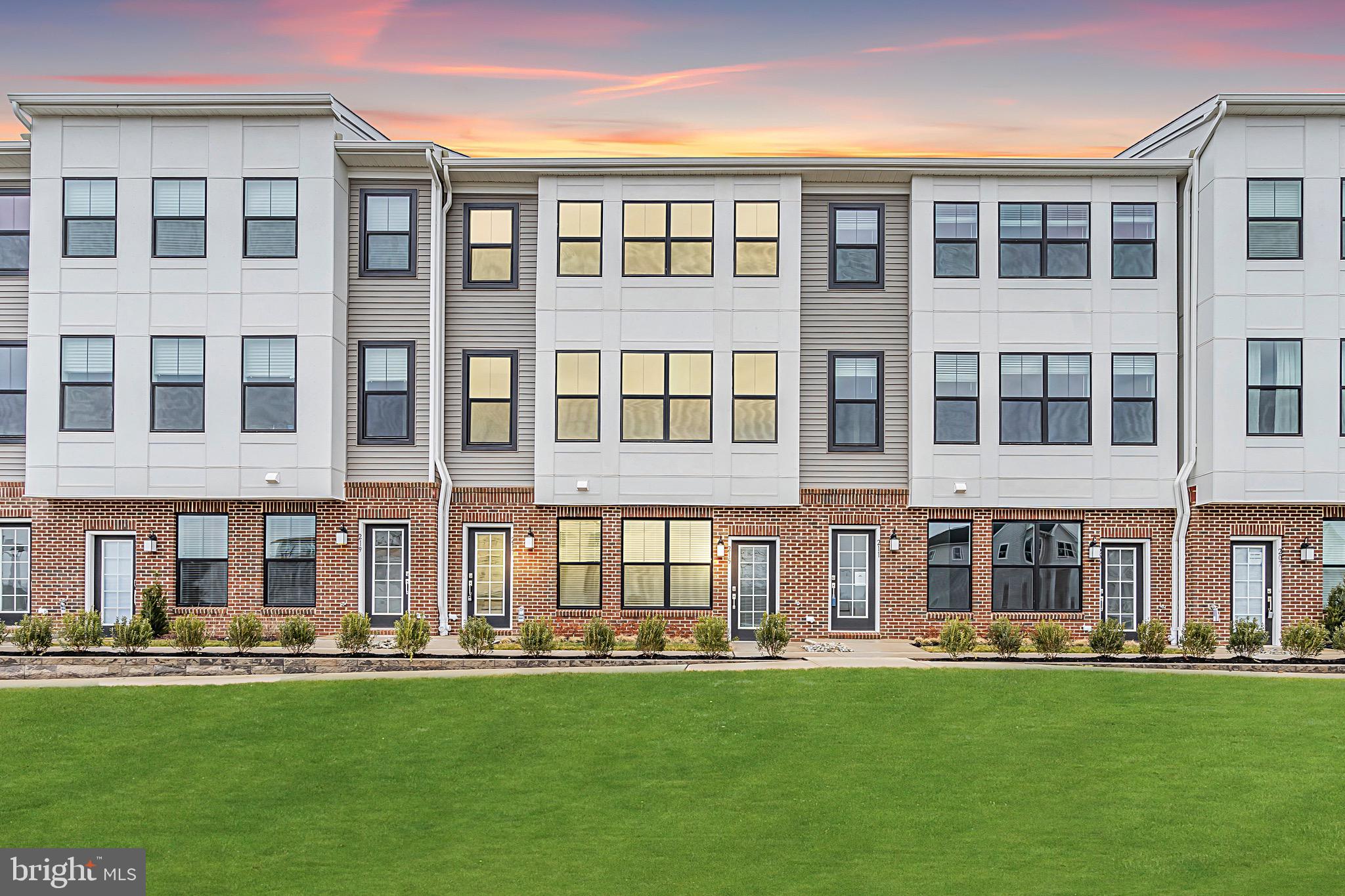 front view of an apartment building with a yard