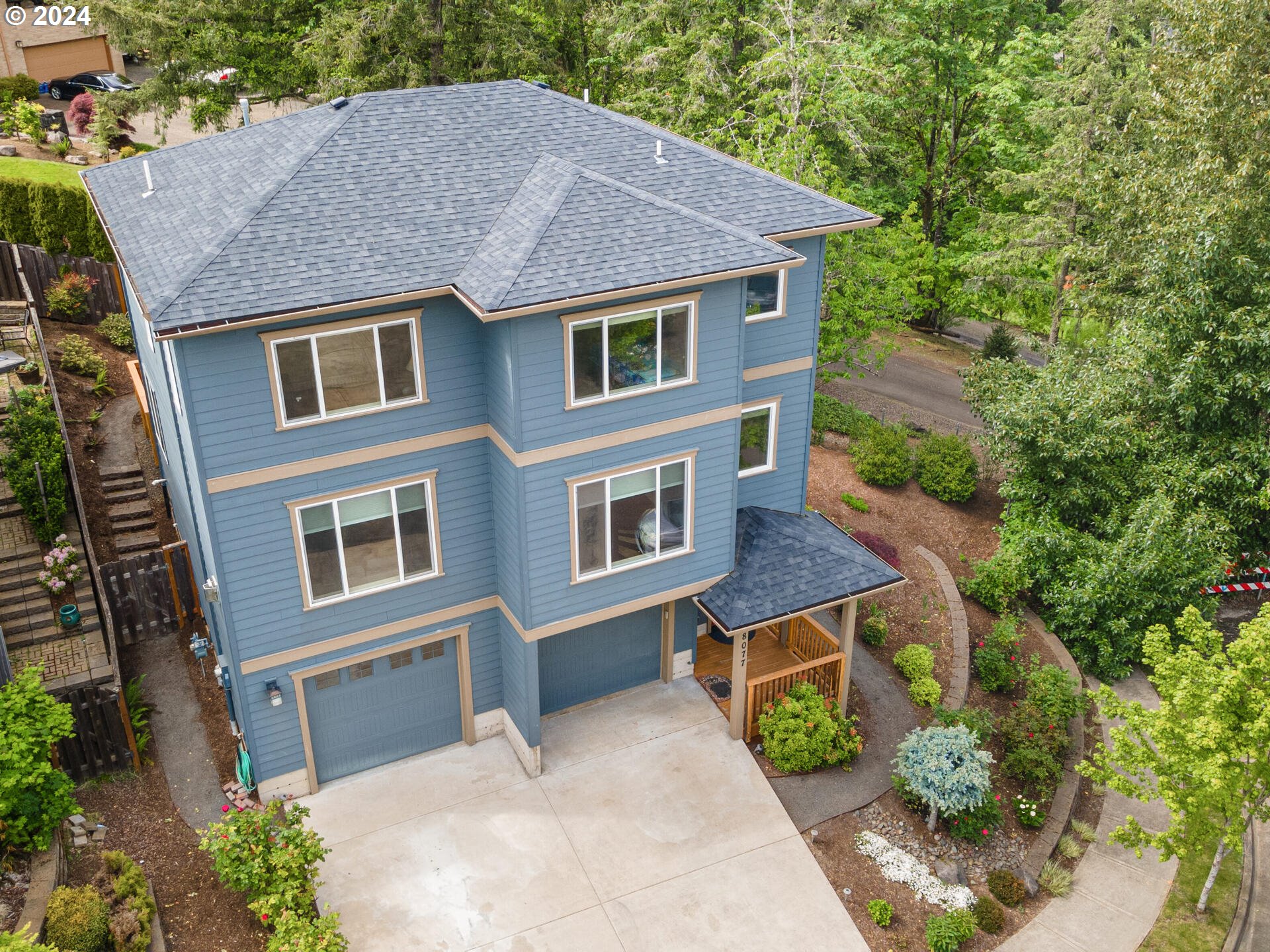 a aerial view of a house next to a yard