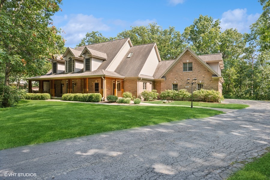 a front view of house with yard and green space