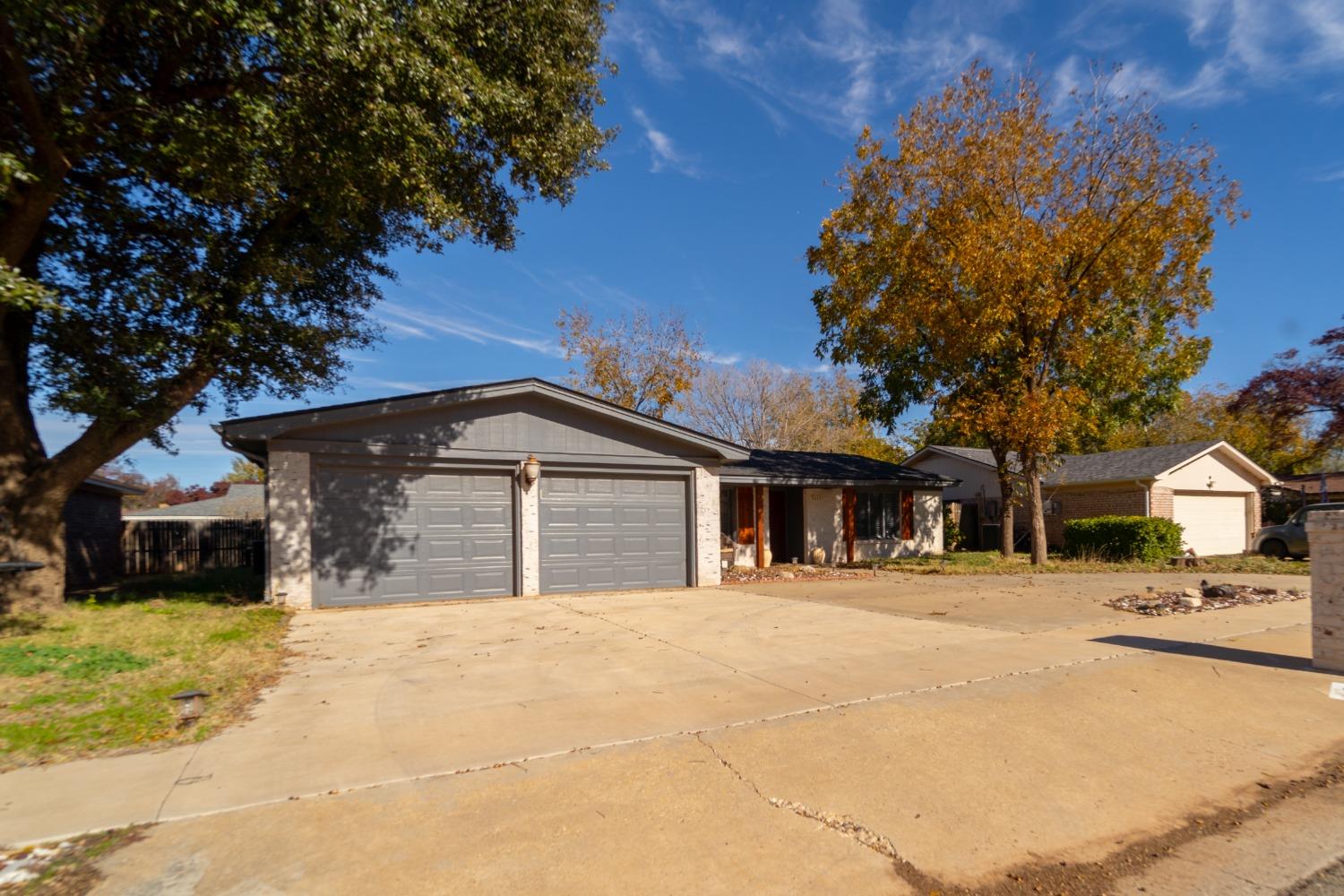 a front view of a house with a yard with seating space