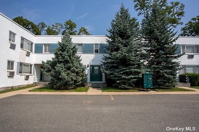 a view of house with outdoor space and parking