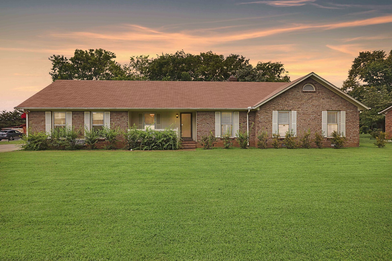 a front view of a house with a garden