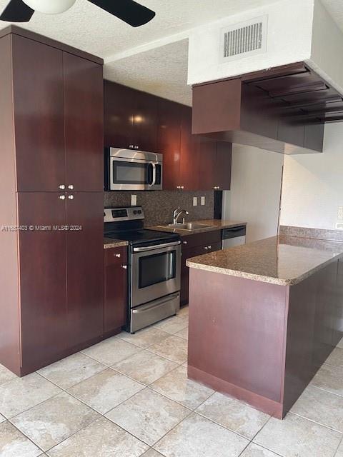 a kitchen with stainless steel appliances granite countertop a refrigerator and a stove