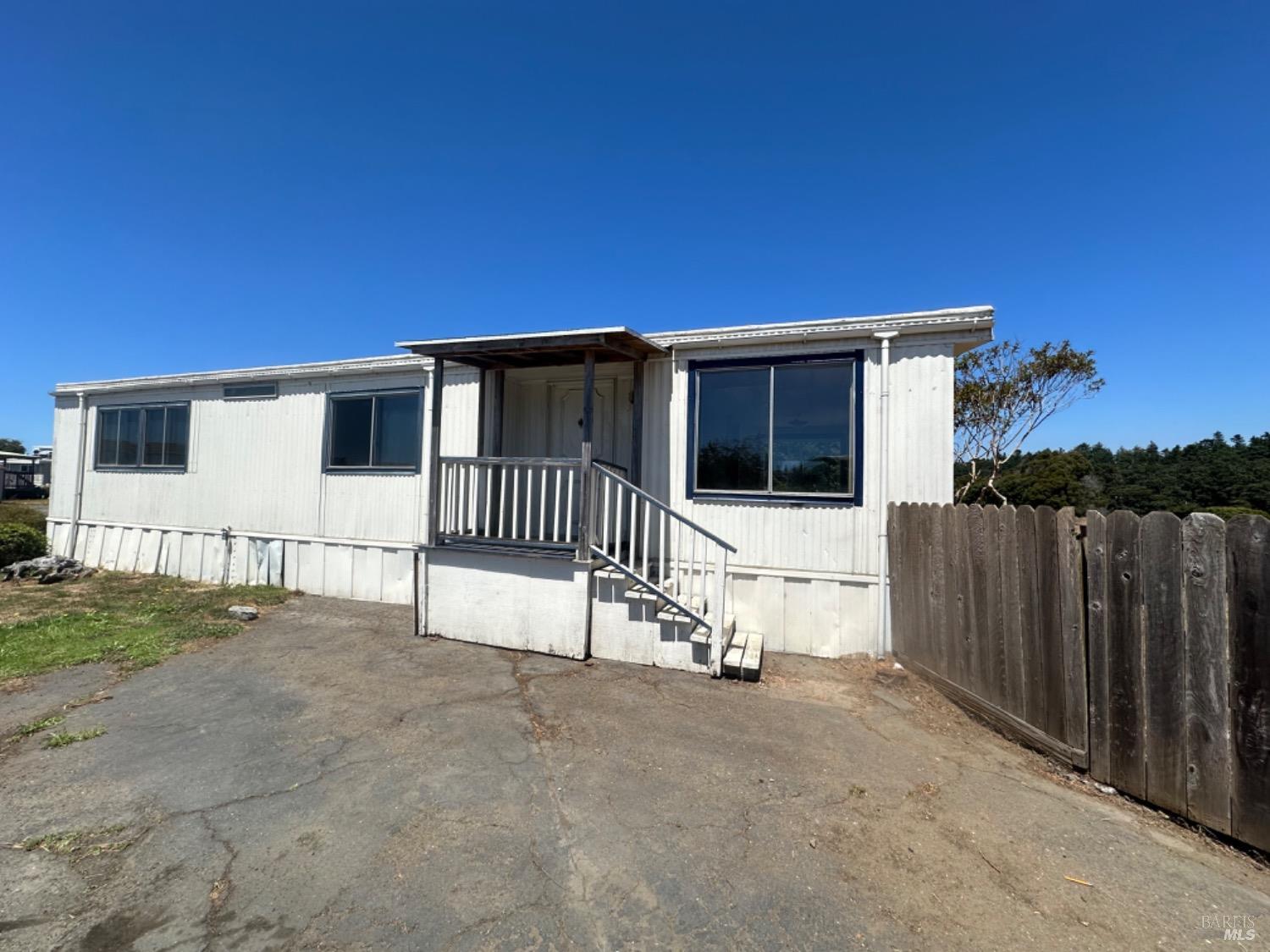 a view of a house with a wooden fence